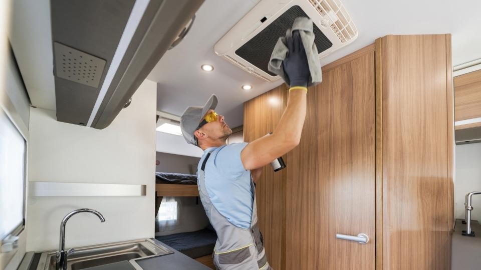 worker cleaning ac at rental unit