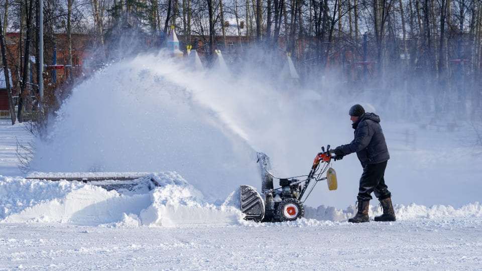 snow being cleared through the snow blower